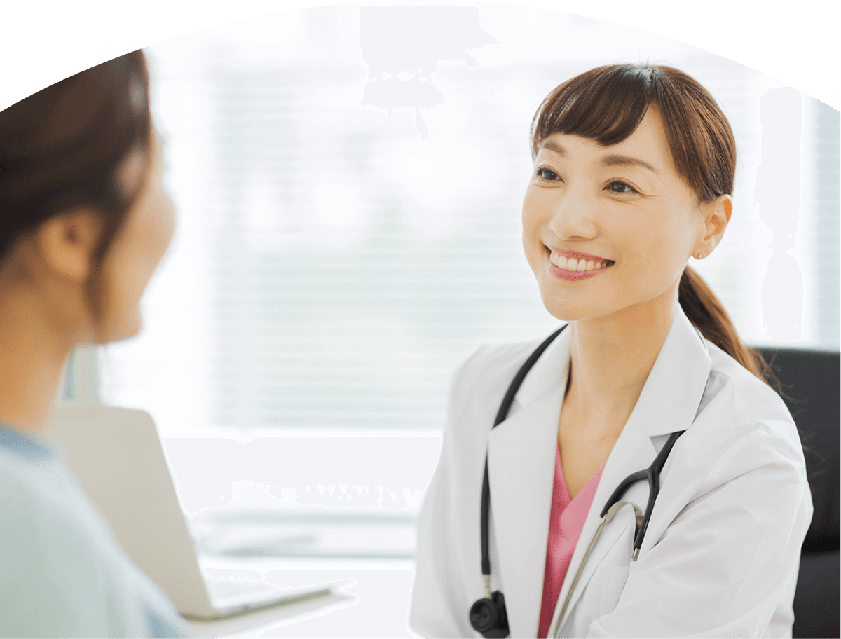笑顔で患者の話を聞く女医