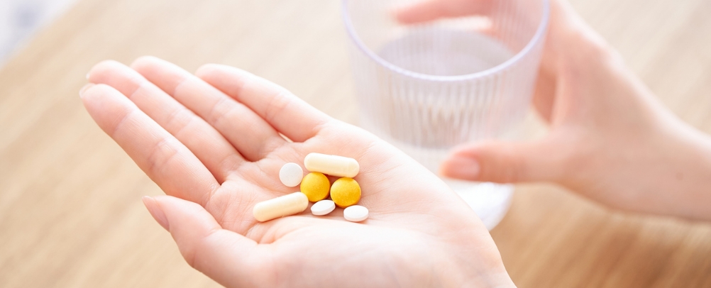 手のひらに並べた漢方薬などの薬